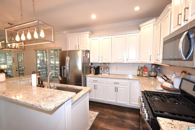 kitchen with decorative light fixtures, stainless steel appliances, white cabinetry, and ornamental molding