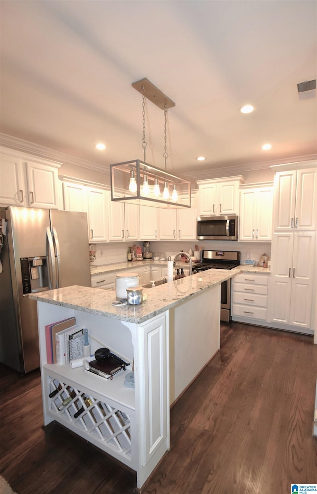 kitchen with appliances with stainless steel finishes, white cabinetry, and pendant lighting