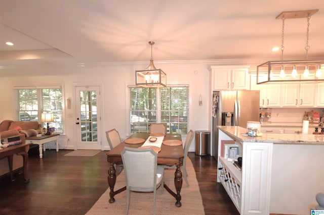 dining room featuring a wealth of natural light, dark wood-type flooring, a notable chandelier, and ornamental molding