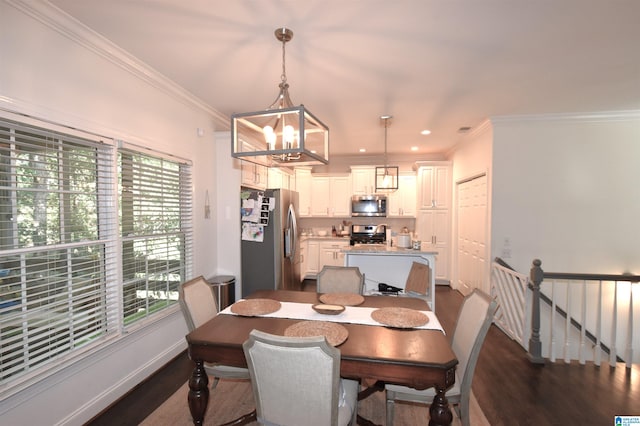 dining room with dark hardwood / wood-style floors, plenty of natural light, and crown molding