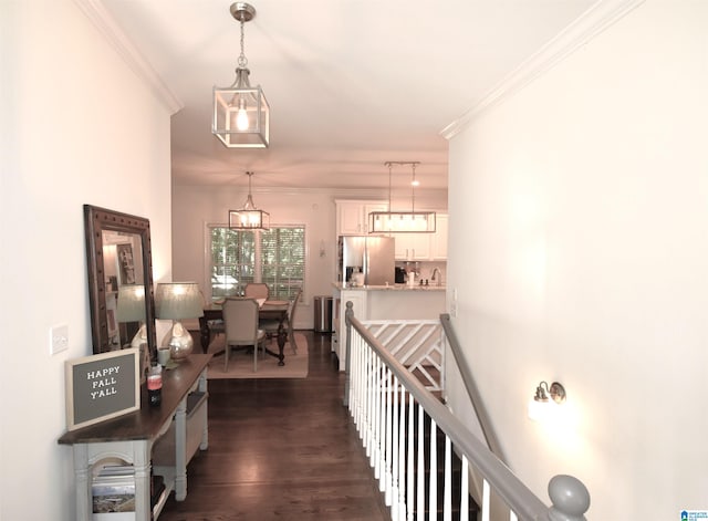 hall featuring a chandelier, dark hardwood / wood-style floors, and crown molding