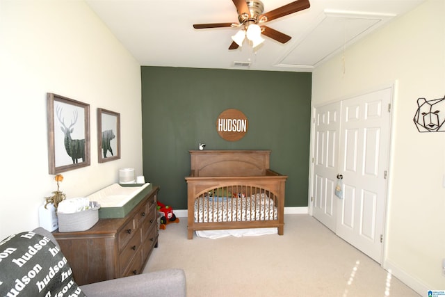 carpeted bedroom with ceiling fan and a closet