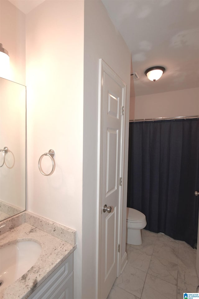 bathroom with vanity and toilet