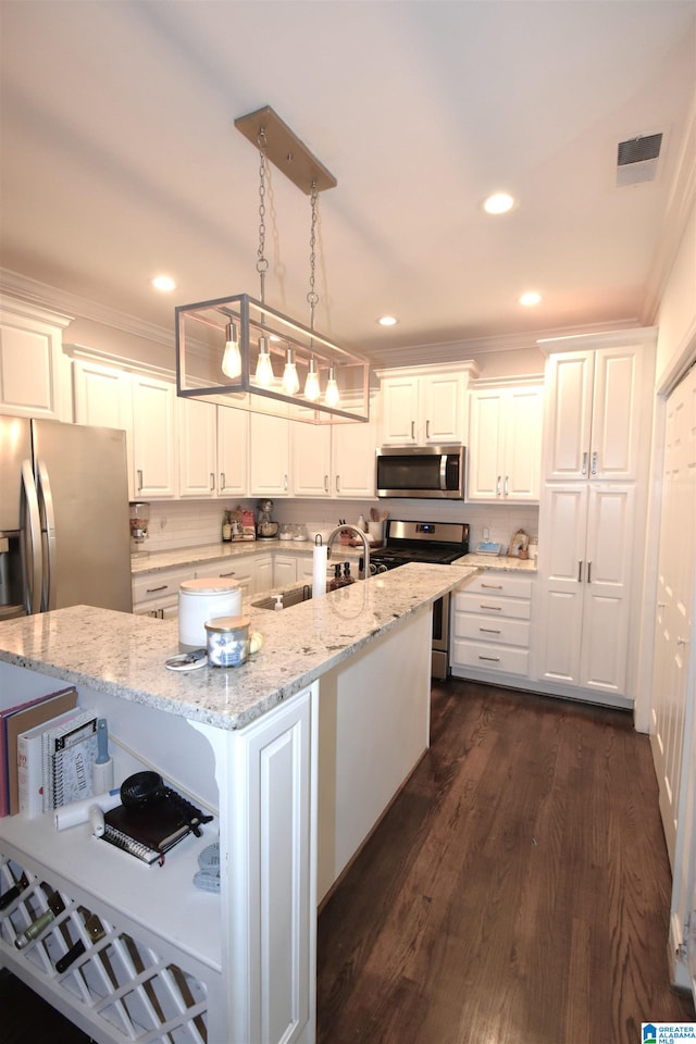 kitchen with an island with sink, white cabinets, and stainless steel appliances