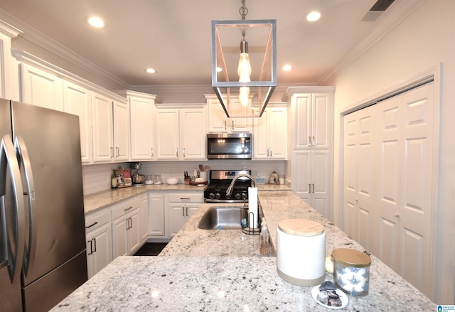 kitchen with light stone countertops, white cabinetry, hanging light fixtures, and stainless steel appliances