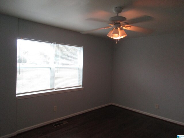 825 Goldwire St SW, Birmingham, AL 35211 - empty room with baseboards, ceiling fan, and dark wood-type flooring