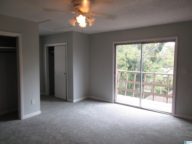 unfurnished bedroom featuring access to exterior, carpet, a textured ceiling, and ceiling fan