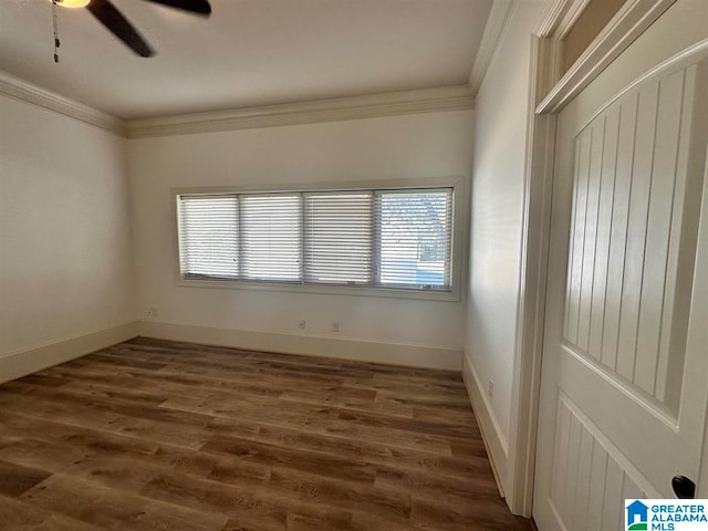 empty room with crown molding, dark hardwood / wood-style flooring, and ceiling fan