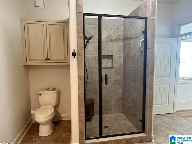 bathroom with a shower with door and toilet