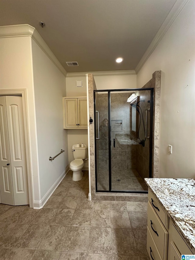 bathroom with vanity, toilet, a shower with shower door, and crown molding