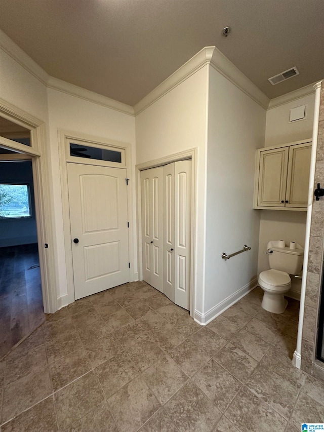 bathroom featuring toilet and crown molding