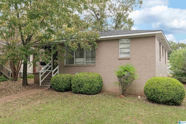 view of side of property with a lawn