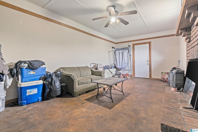 living room featuring ceiling fan, a fireplace, and ornamental molding