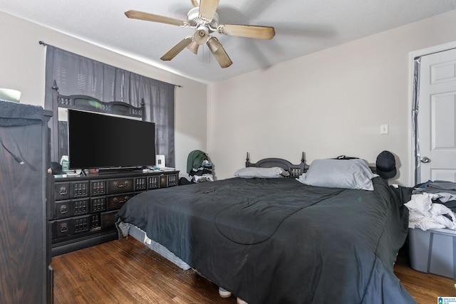 bedroom with ceiling fan and dark hardwood / wood-style floors