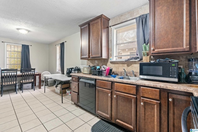 kitchen with tasteful backsplash, sink, light tile patterned flooring, and appliances with stainless steel finishes