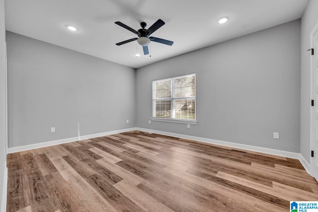 empty room featuring ceiling fan and light hardwood / wood-style floors