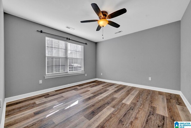 unfurnished room featuring hardwood / wood-style flooring and ceiling fan