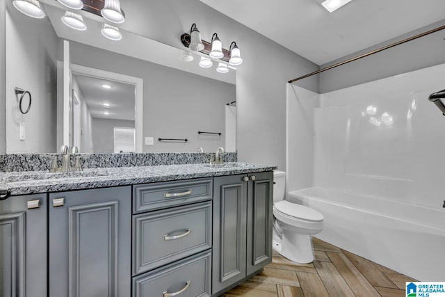 full bathroom featuring vanity, toilet, shower / tub combination, and parquet flooring