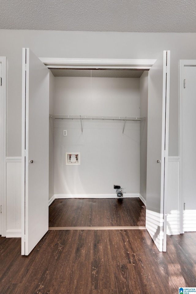 laundry room featuring hookup for a washing machine, a textured ceiling, and dark wood-type flooring