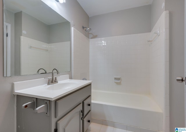 bathroom with tile patterned flooring, vanity, and tiled shower / bath combo