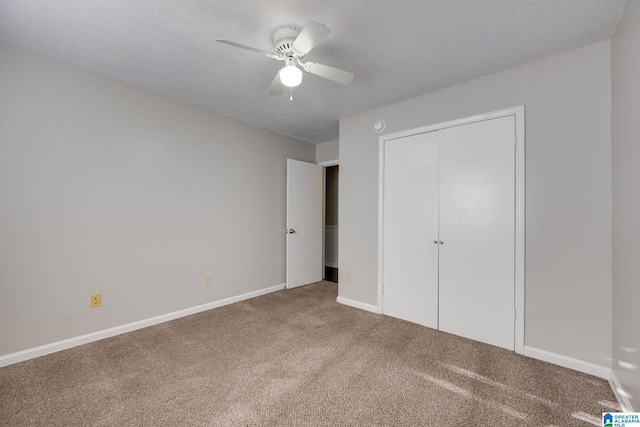 unfurnished bedroom with ceiling fan, carpet floors, a textured ceiling, and a closet