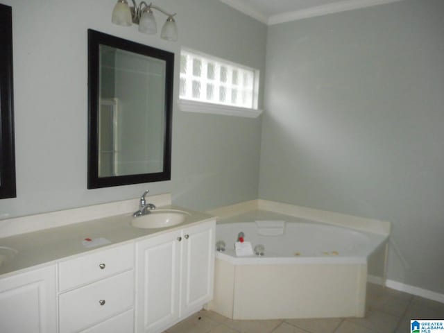 bathroom featuring tile patterned flooring, vanity, ornamental molding, and a bath