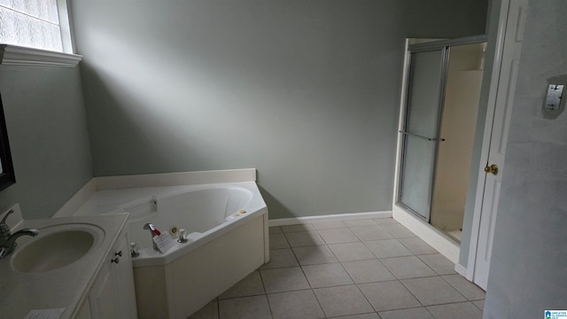 bathroom featuring tile patterned flooring, vanity, and plus walk in shower