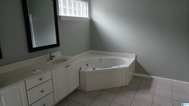 bathroom with a tub, tile patterned flooring, and vanity