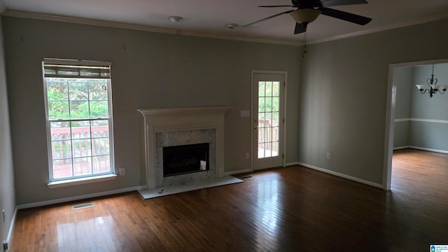 unfurnished living room featuring dark hardwood / wood-style flooring, plenty of natural light, and a premium fireplace