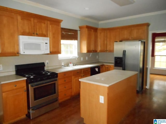 kitchen with stainless steel appliances, crown molding, dark wood-type flooring, sink, and a kitchen island