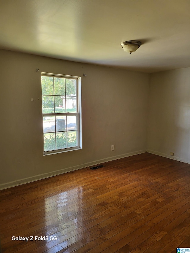 unfurnished room featuring dark hardwood / wood-style floors