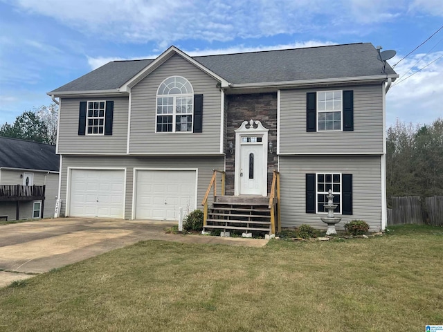 bi-level home featuring a garage and a front lawn