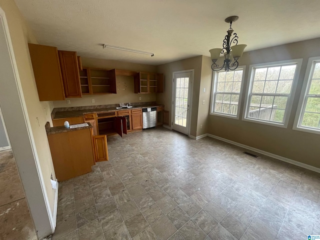 kitchen featuring a textured ceiling, stainless steel dishwasher, decorative light fixtures, and an inviting chandelier