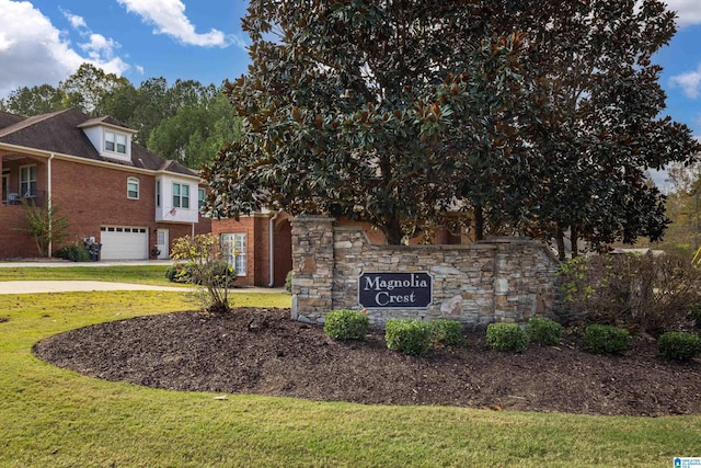 community / neighborhood sign with a yard