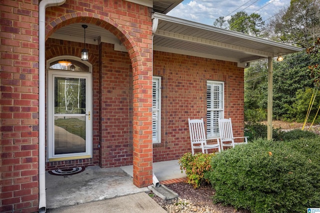 view of exterior entry with a porch