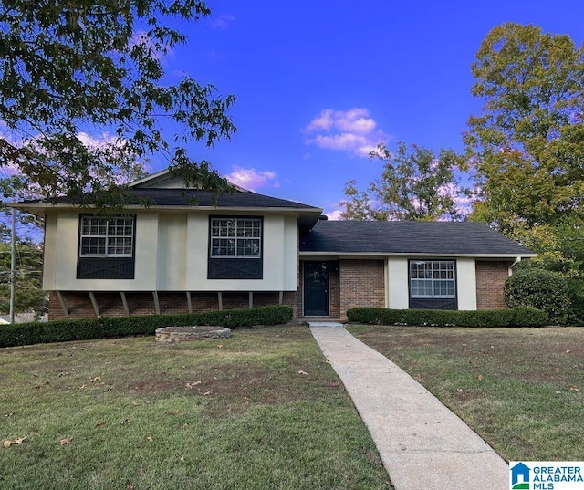 tri-level home featuring a lawn