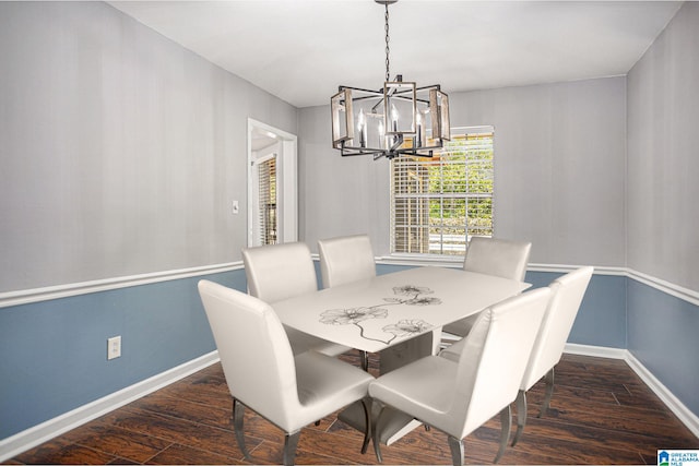 dining space with dark hardwood / wood-style floors and a chandelier