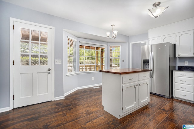 kitchen with white cabinetry, wooden counters, a notable chandelier, stainless steel fridge with ice dispenser, and dark wood-type flooring