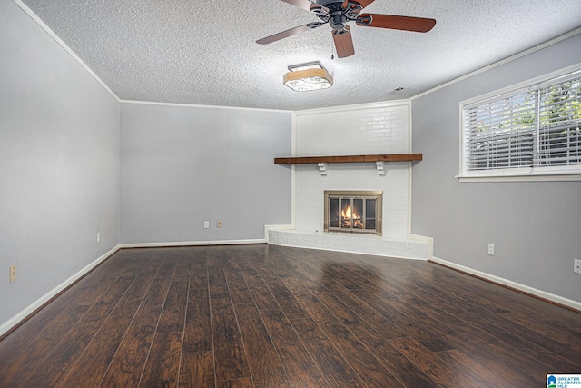 unfurnished living room with ornamental molding, a fireplace, hardwood / wood-style floors, and a textured ceiling