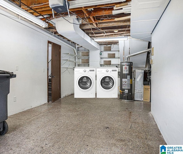 laundry room featuring gas water heater and separate washer and dryer