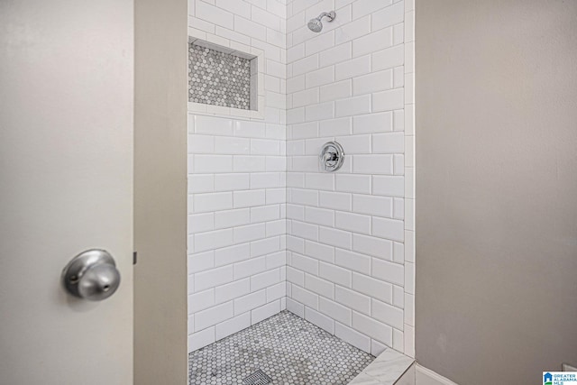 bathroom with tiled shower