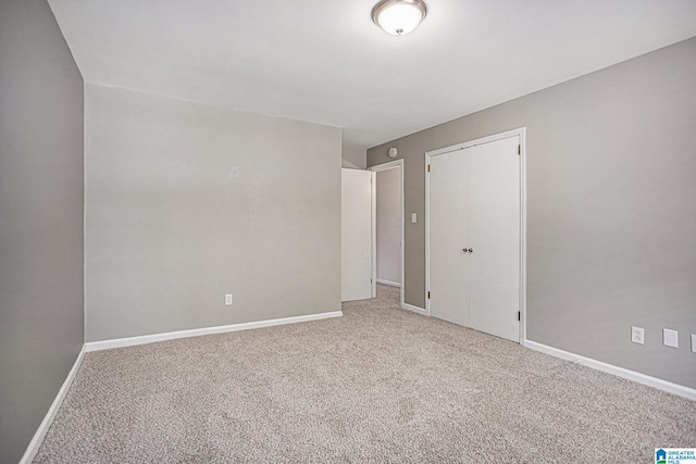 unfurnished bedroom featuring carpet floors and a closet