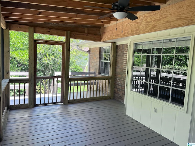 unfurnished sunroom featuring plenty of natural light and ceiling fan