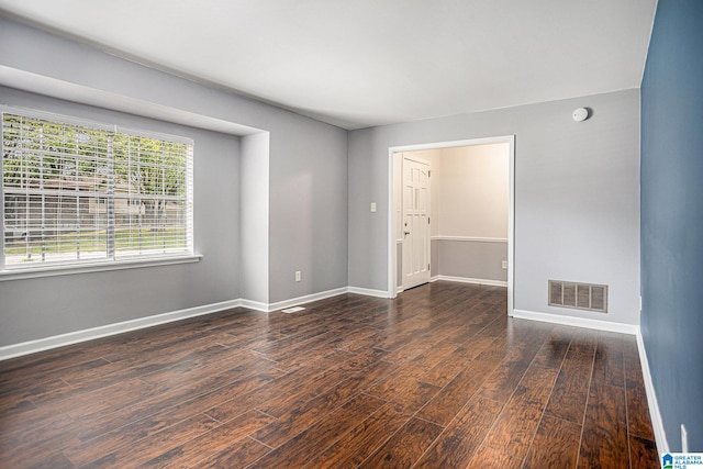 unfurnished room featuring dark wood-type flooring