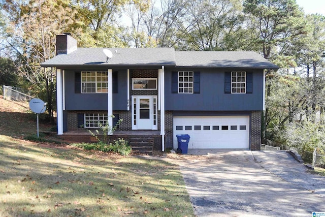 bi-level home with covered porch and a garage