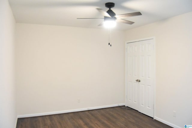 spare room with ceiling fan and dark hardwood / wood-style flooring