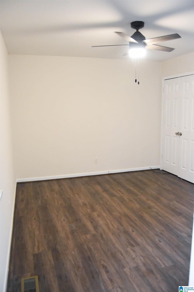 empty room with dark wood-type flooring