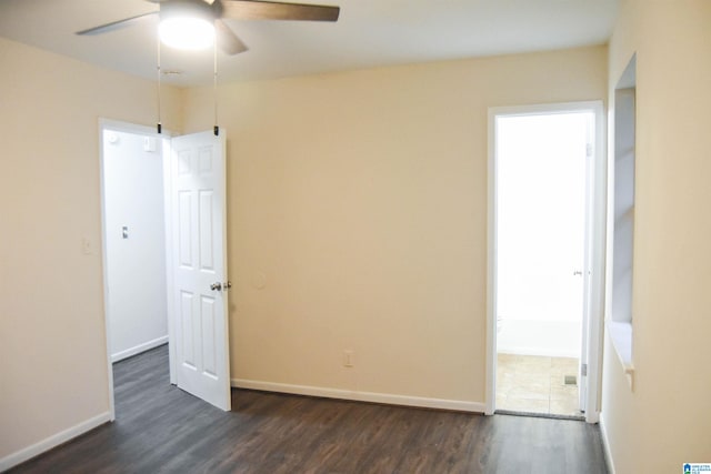 spare room with ceiling fan and dark hardwood / wood-style flooring