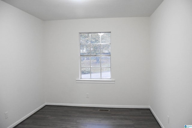 empty room with dark hardwood / wood-style floors