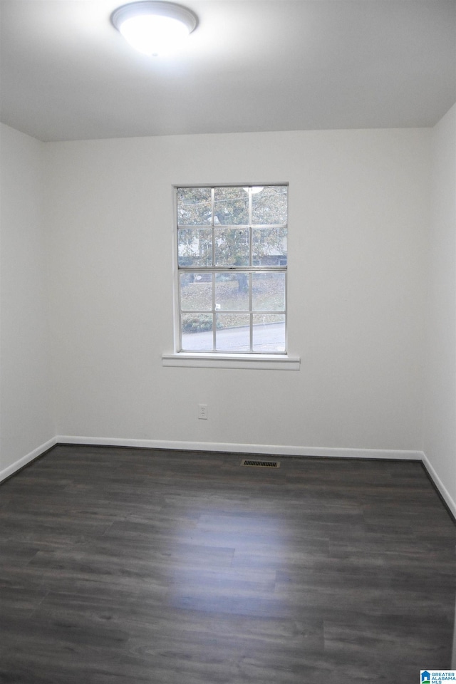 unfurnished room featuring dark hardwood / wood-style floors